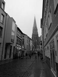 Street amidst buildings against sky in city