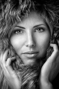 Close-up portrait of beautiful woman wearing fur hood