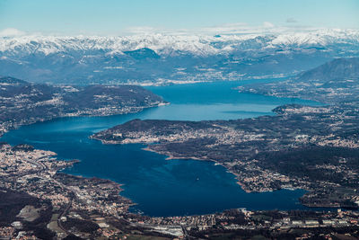 Aerial view of sea and mountains against sky