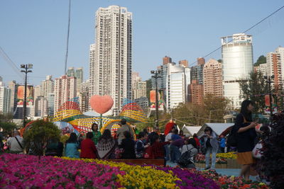 Crowd in city against clear sky