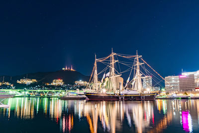 Illuminated city against sky at night