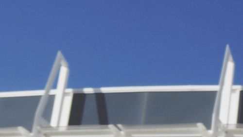 Windmill against clear blue sky