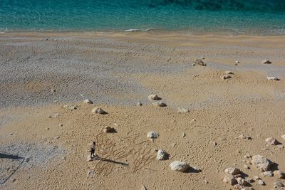 High angle view of footprints on sand at beach