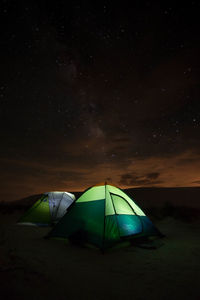 Tents against sky at night