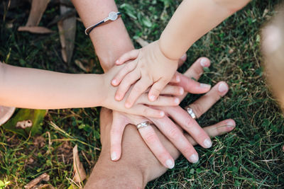 Close-up of hands touching grass