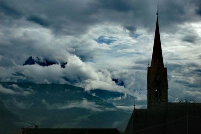 Low angle view of tower against cloudy sky