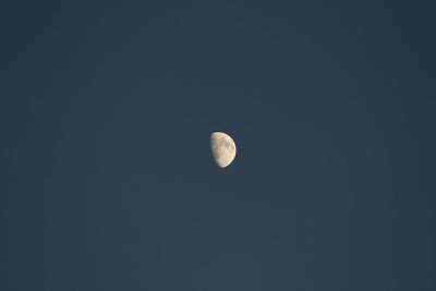 Low angle view of moon against clear sky