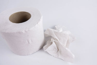 Close-up of toilet paper over white background