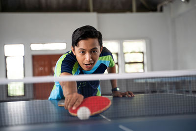 Boy playing tennis