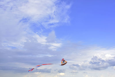 Low angle view of flag against blue sky