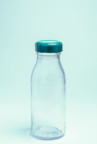 Close-up of glass bottle against blue background