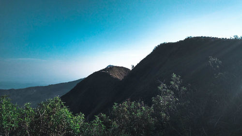 Scenic view of mountains against clear blue sky
