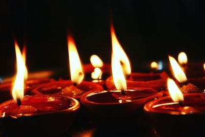 Close-up of lit candles with black background