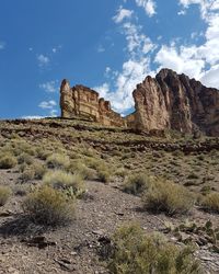 Rock formations on landscape against sky