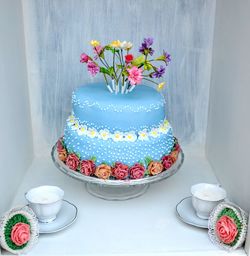 Flower vase on table against wall