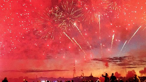 Low angle view of fireworks against sky at night