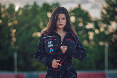 Portrait of a beautiful young woman standing outdoors