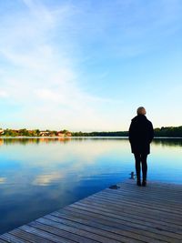Rear view of man standing on pier