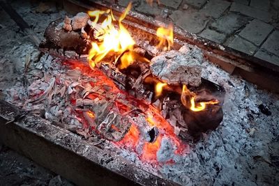 High angle view of fire on wood