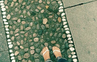 Low section of person standing on footpath