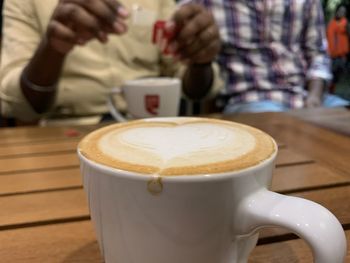 Close-up of cappuccino on table at cafe