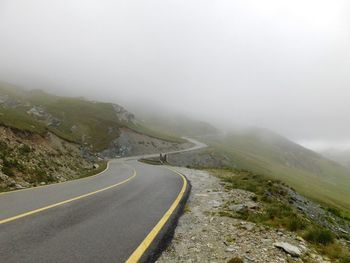 Scenic view of mountains against sky during foggy weather