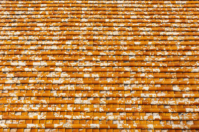 Tile roof texture, background of red tiles with white spots