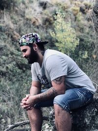Young man wearing sunglasses in forest