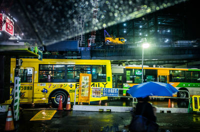 Man in illuminated city at night