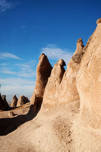 Rock formations in desert against blue sky