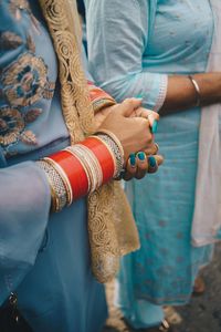 Midsection of couple holding hands