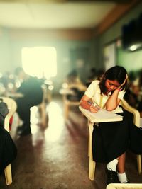 Students writing exam in classroom