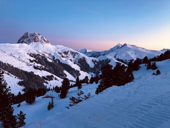 Scenic view of snow covered mountains against sky