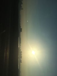 Silhouette of vapor trail in sky during sunset