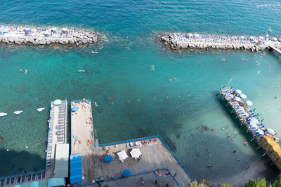 High angle view of sailboats moored at harbor