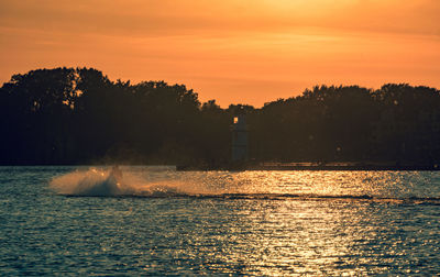 Scenic view of sea against orange sky