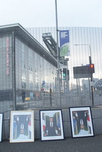 Information sign on street against buildings in city