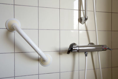 Close-up of electric lamp on tiled floor