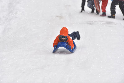 Boy playing on snow field