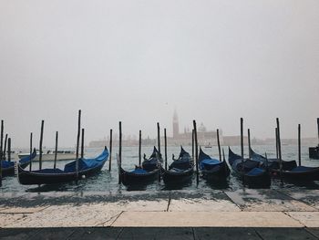Gondolas moored in water