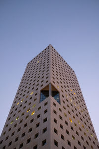 Low angle view of modern building against clear blue sky