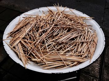High angle view of toothpicks in plate on table