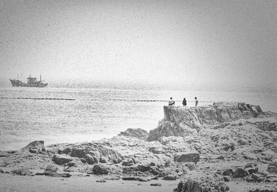 Tourists on rocks at beach