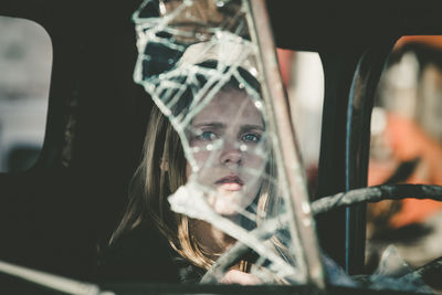 Close-up of woman in abandoned car