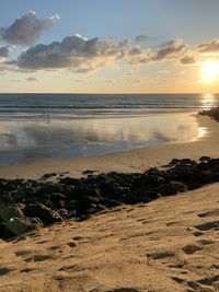 Scenic view of beach against sky during sunset