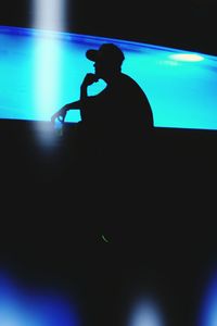 Silhouette of woman in dark room