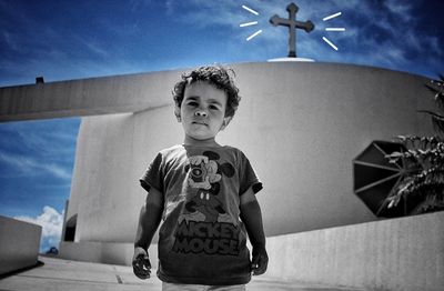 Boy standing against sky