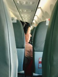 Close-up of woman sitting in airplane