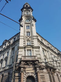 Low angle view of clock tower against sky