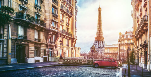 Vintage car on street against eiffel tower in city